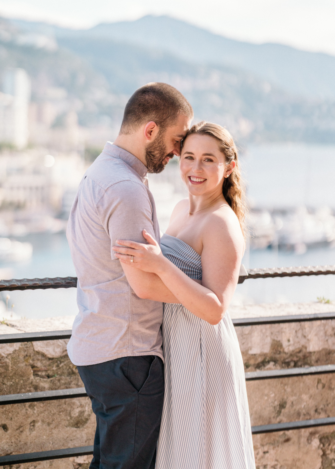 newlyweds embrace in monaco harbor