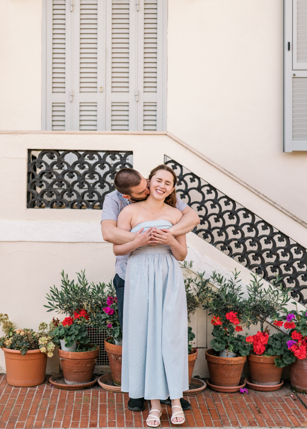 husband kisses wife on neck in monaco