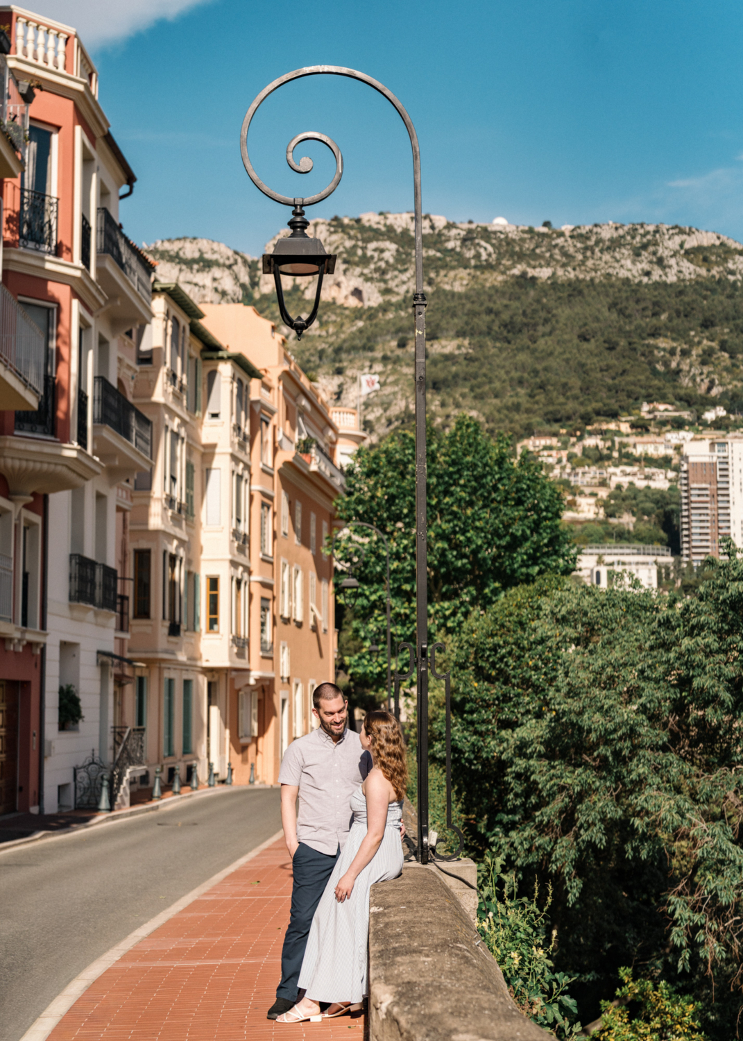 couple sit and talk on the streets of monaco