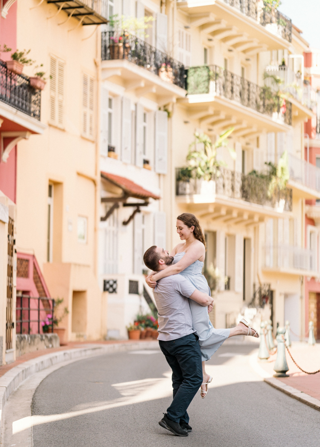 husband lifts wife on the streets of monaco