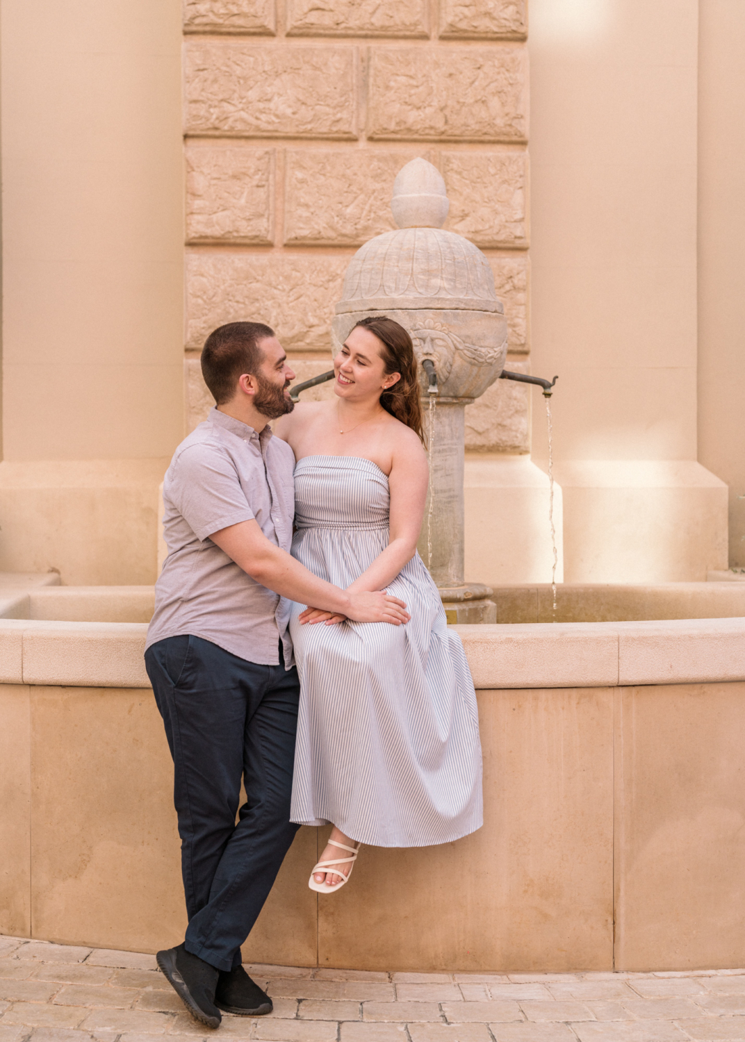honeymooners pose on a fountain in monaco