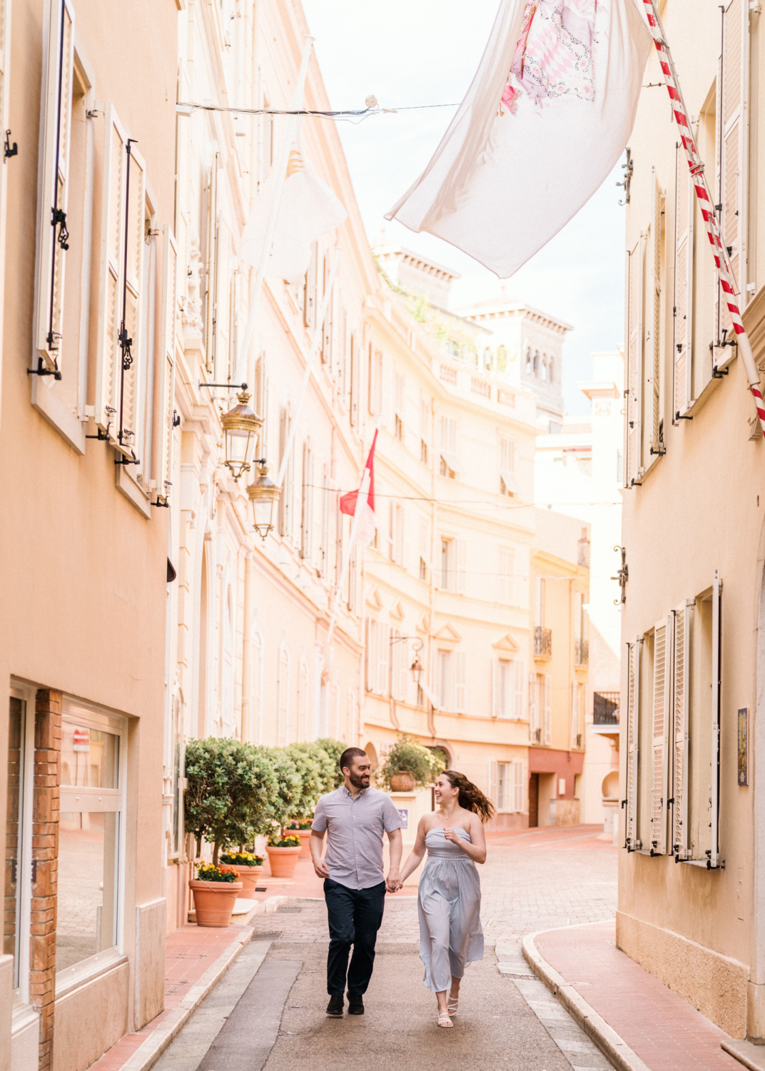 cute couple run through the streets of monaco