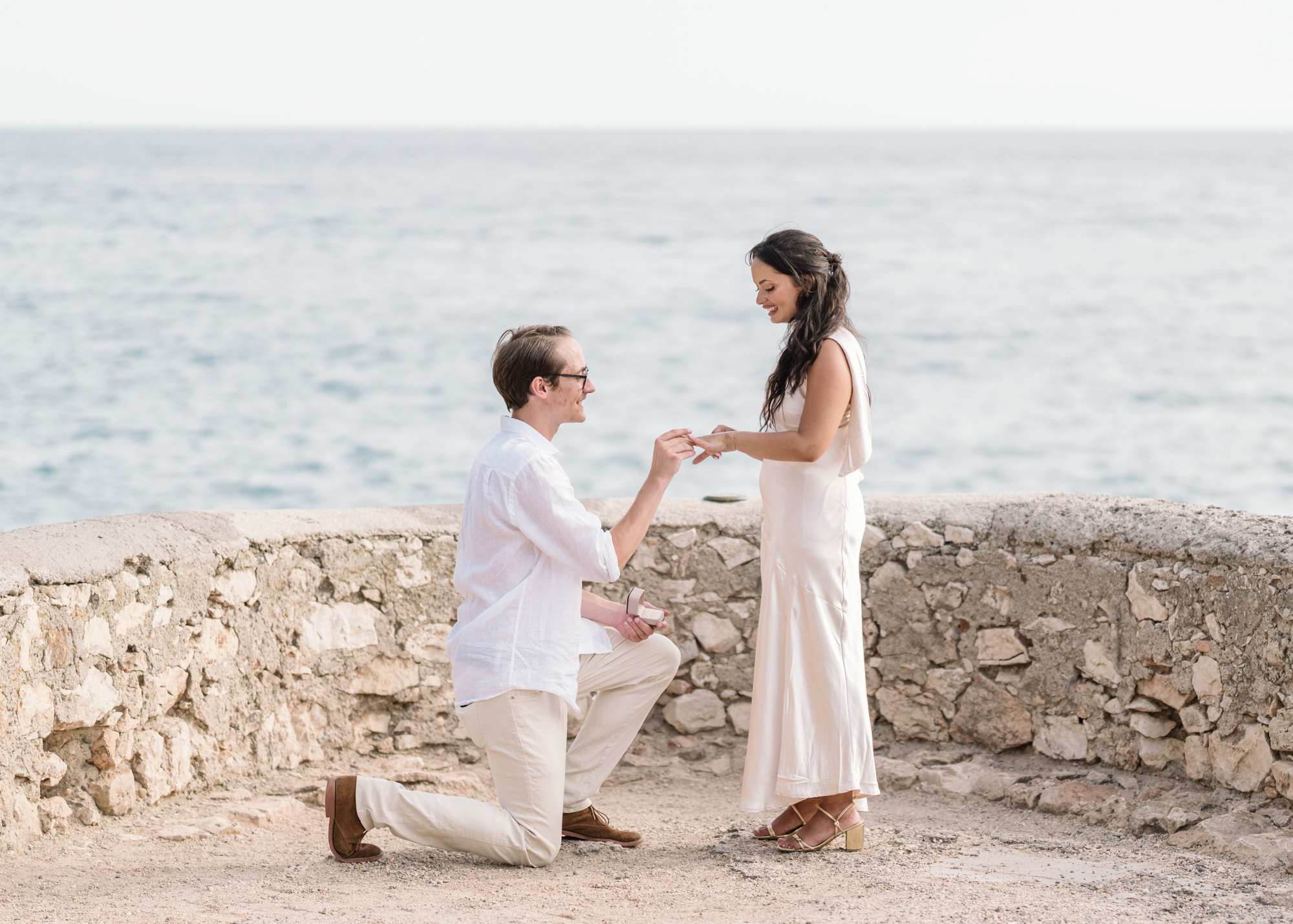 man puts diamond ring on womans finger in nice france