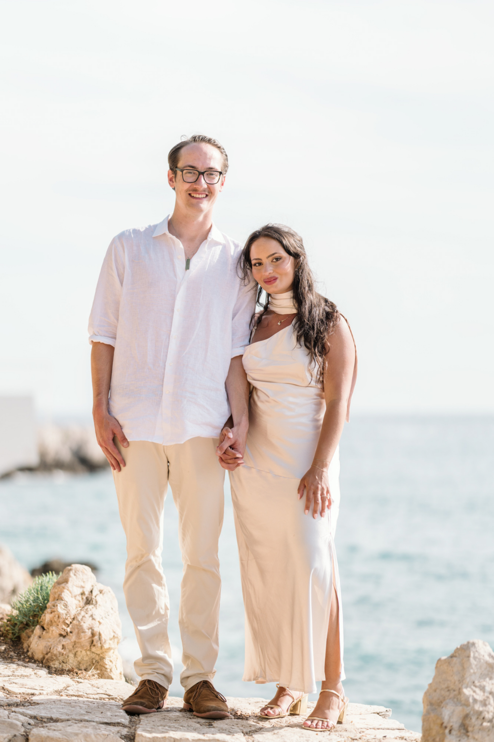 newly engaged couple holding hands along the sea in nice france