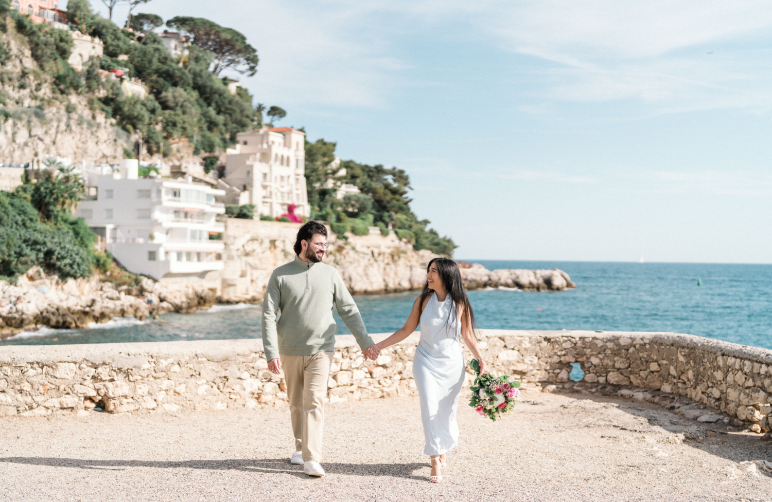happy newly engaged couple walk in nice, france