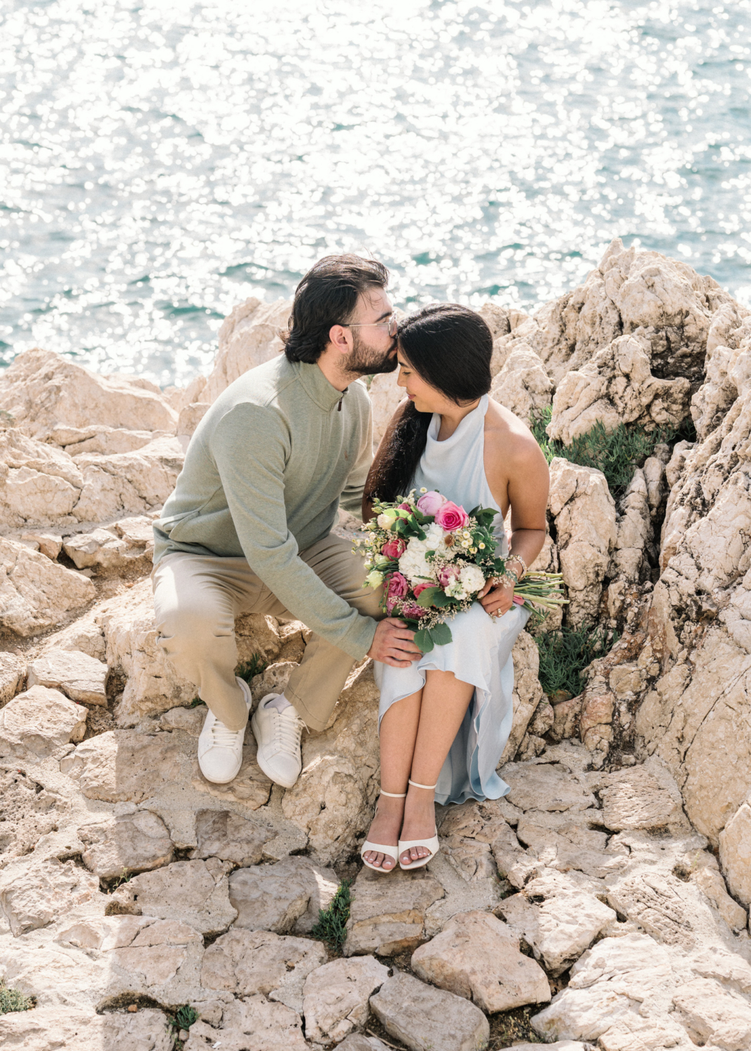man kisses fiancee on forehead in nice, france