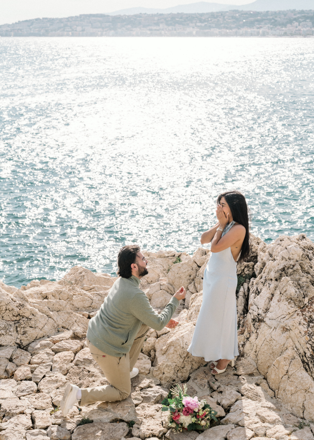 woman is shocked as man proposes in nice, france