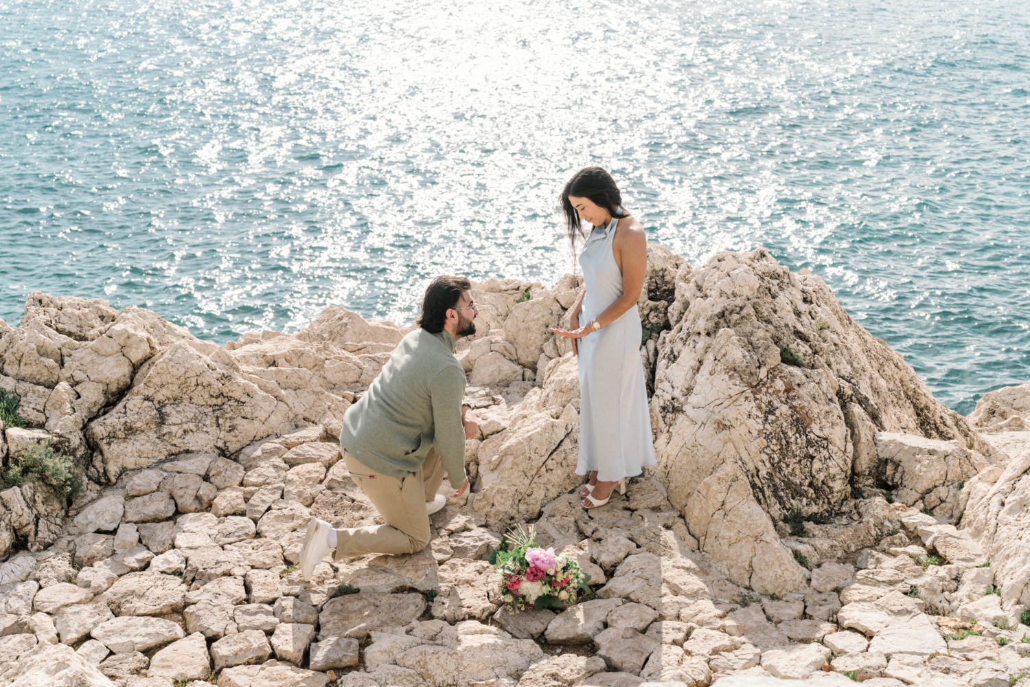 woman looks down at her new engagement ring in nice, france