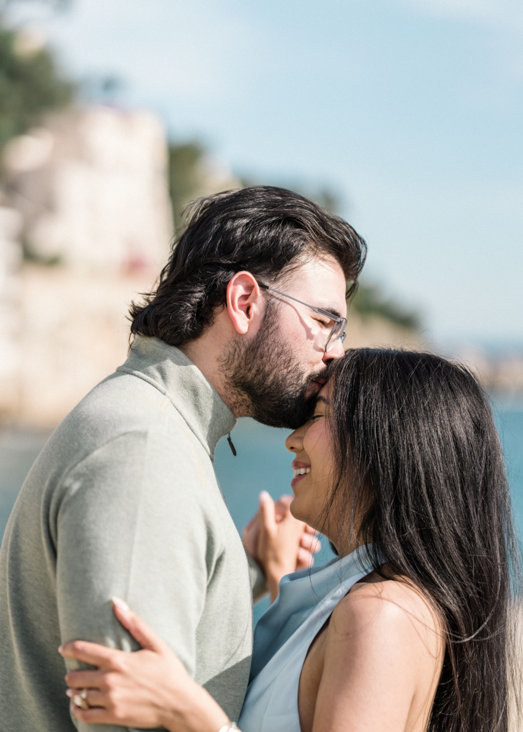 man kisses fiancee on head