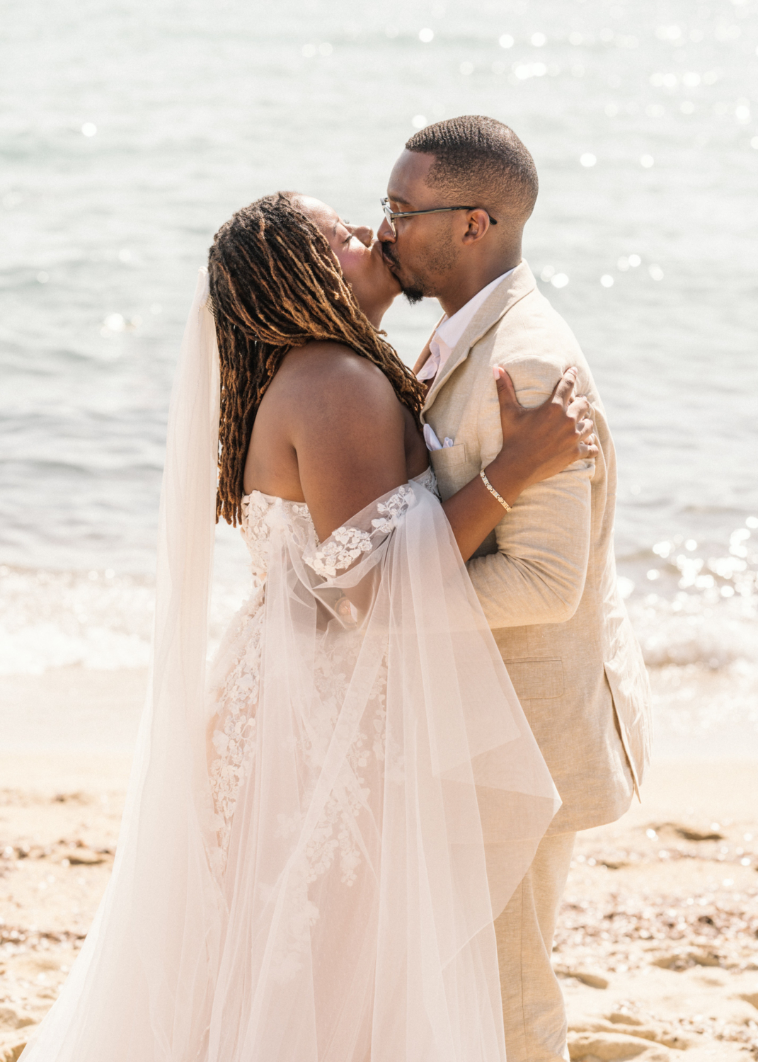 bride and groom kiss on the beach in saint tropez