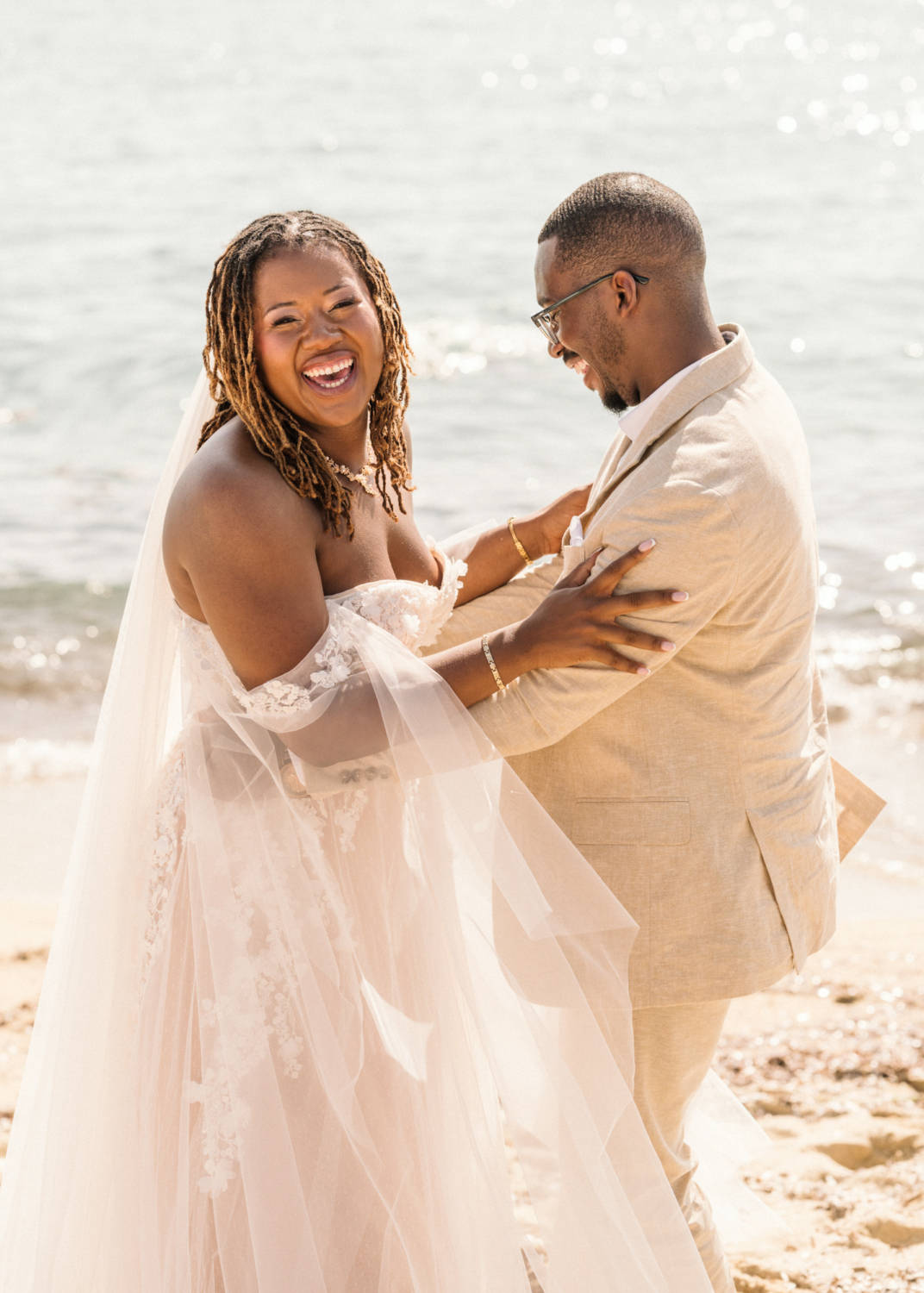 bride and groom laugh on the beach in saint tropez