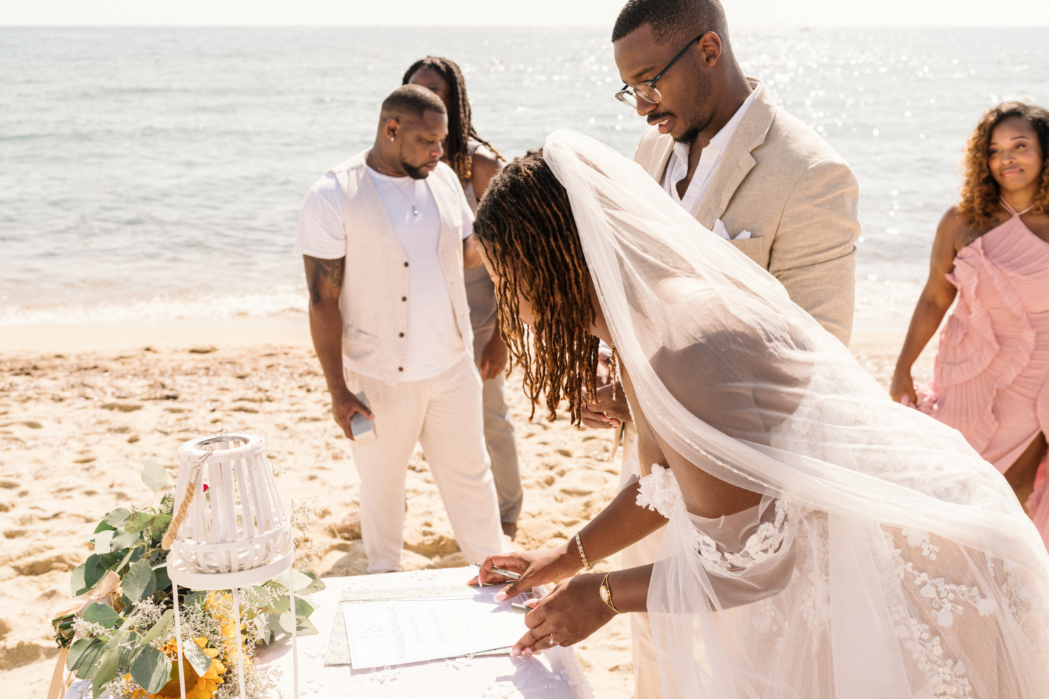 bride and groom sign wedding certificate on the beach in saint tropez