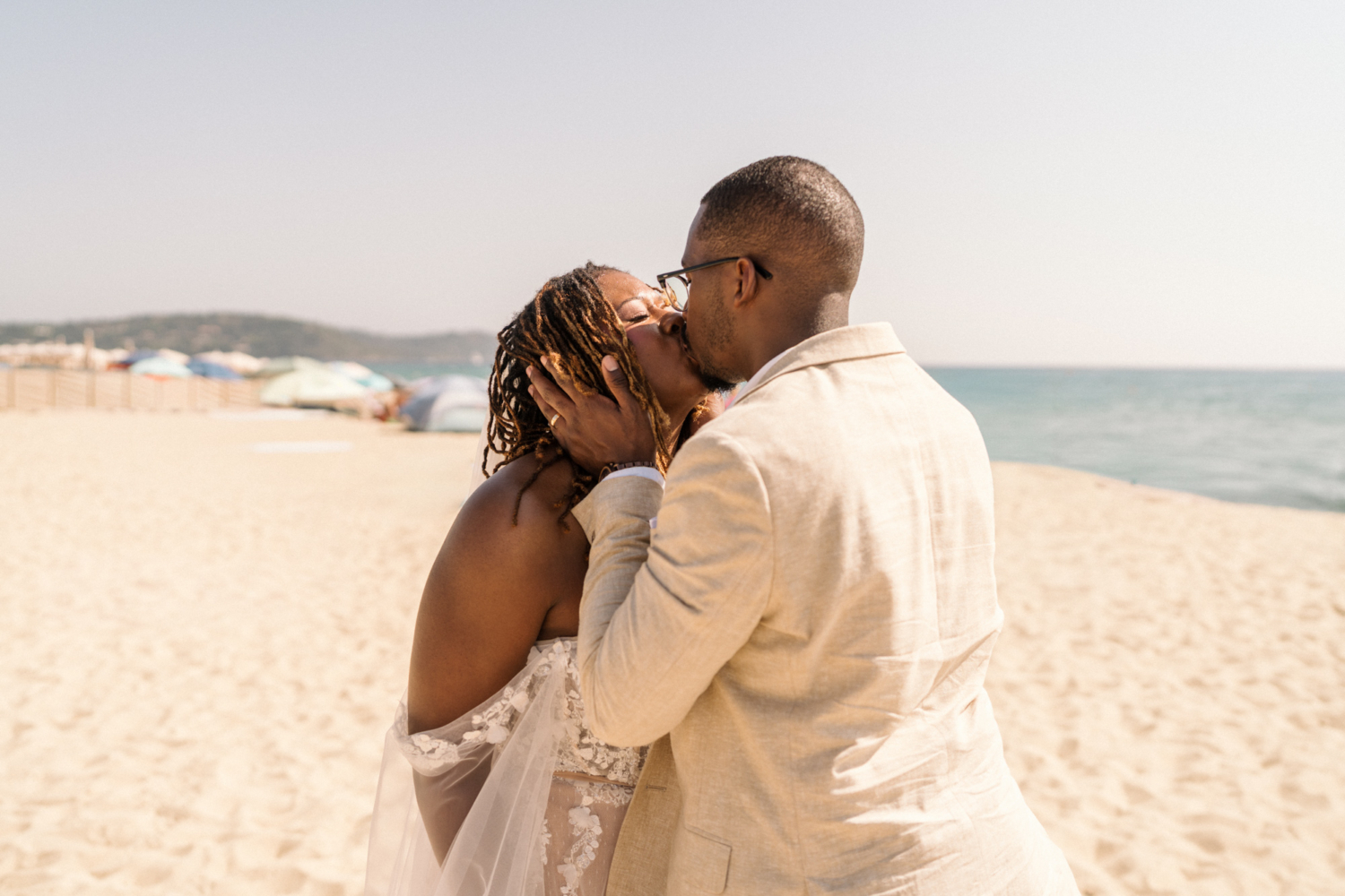 bride and groom kiss passionately on the beach in saint tropez