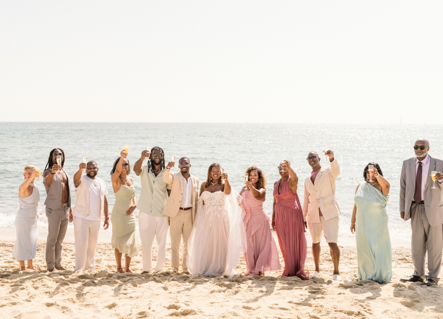 group cheers the bride and groom on the beach in saint tropez