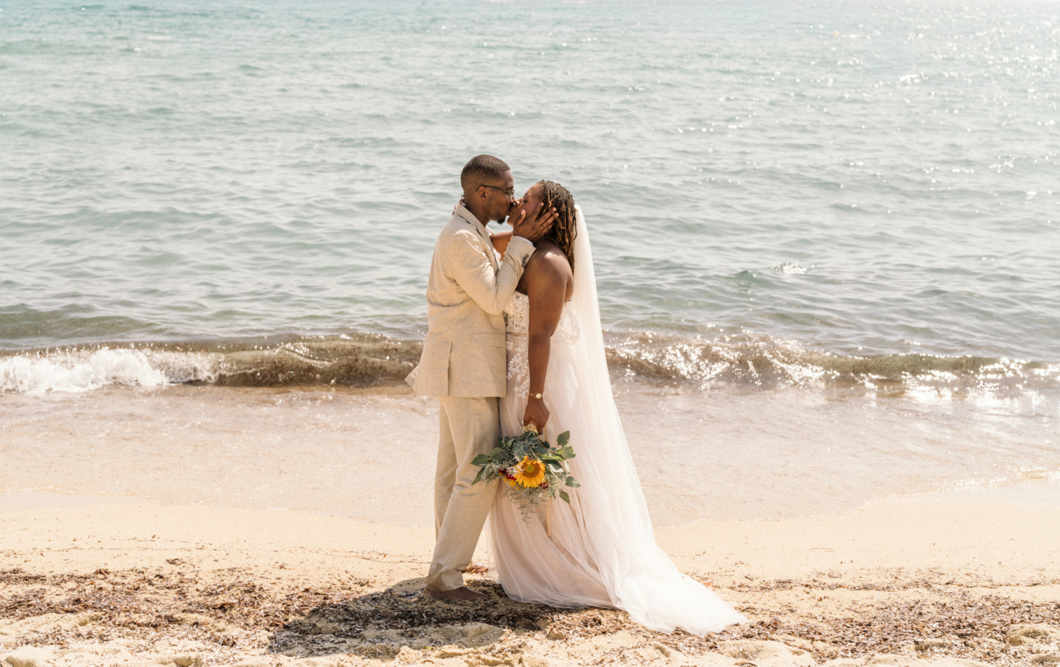 bride and groom kiss on the beach in saint tropez