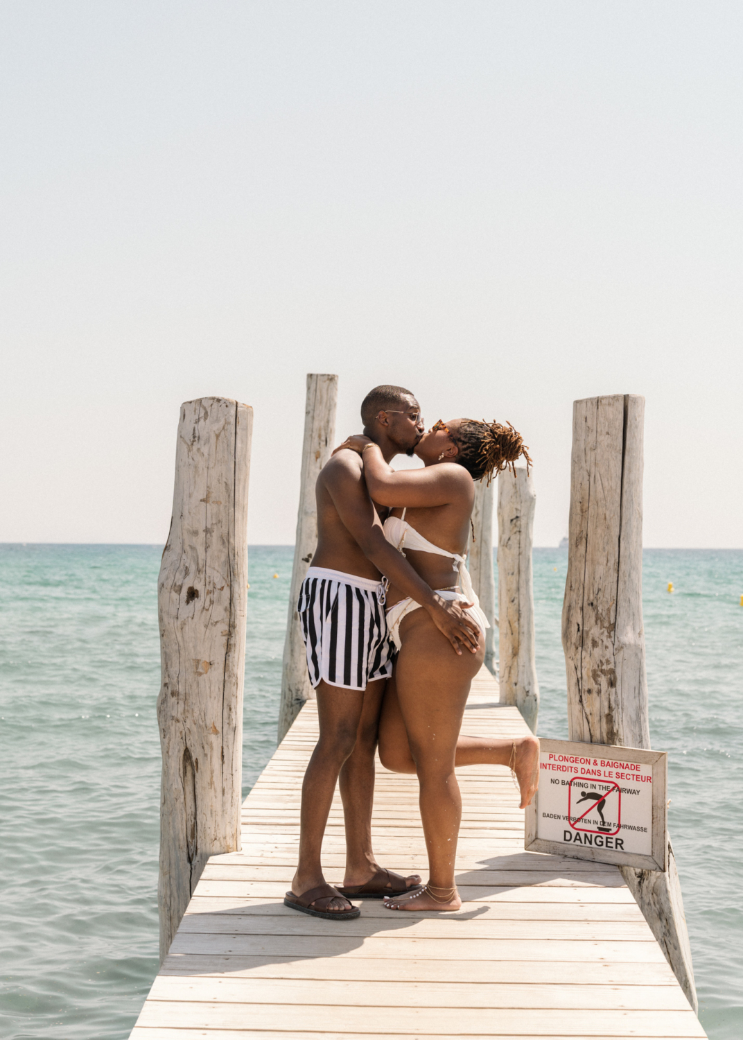 bride and groom kiss on a dock in saint tropez